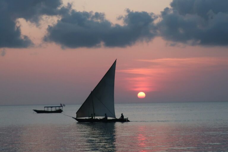 Sailing boat on calm water at golden hour, northern Zanzibar